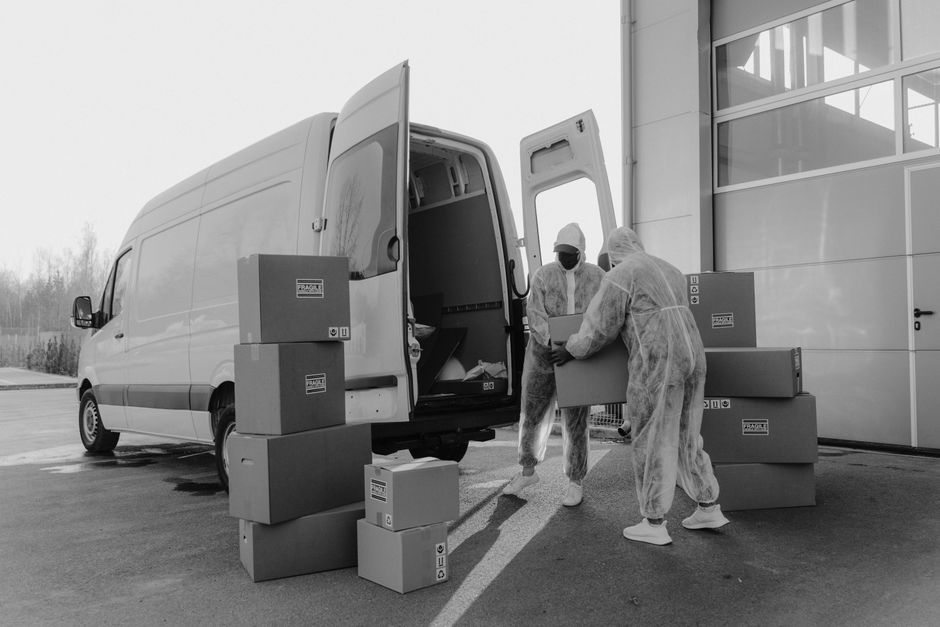 Worker loading boxes into a moving truck