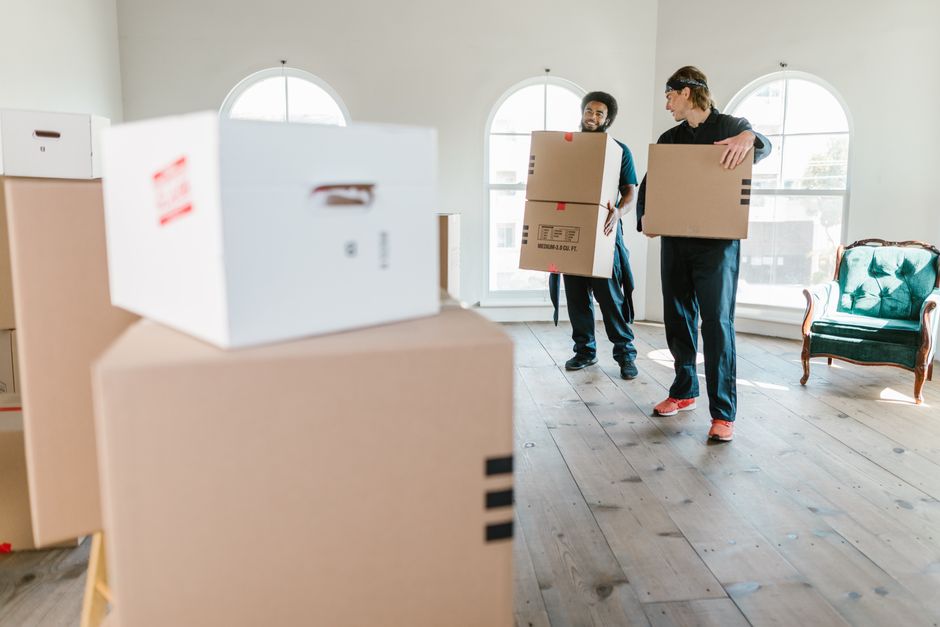 Movers carrying boxes to a moving truck