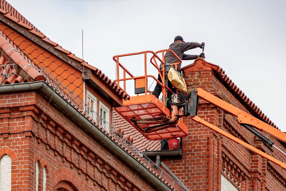 Gutter cleaning from a ladder